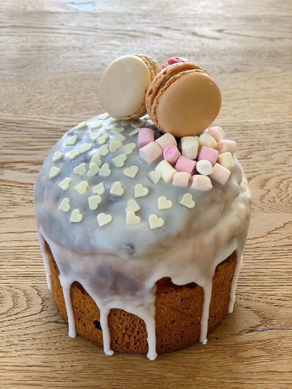 Russian Easter Cake (Kulich) decorated with macarons, marshmallow and white chocolate